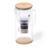 A water filter pitcher with a bamboo lid sits on a white background, isolated. Produktbild-Vorschau