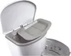 A close-up view of the top of a white diaper pail with its lid open, revealing a gray insert tray. Produktbild-Vorschau