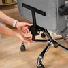 A close-up of someone adjusting a part of a gray office chair. Produktbild-Vorschau