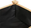 Close-up view of the interior corner of a wooden raised garden bed lined with black fabric. Podgląd zdjęcia produktu