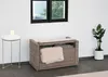 A bench with storage and a cushion is placed next to a small side table with a candle and a potted plant. Náhled obrázku produktu