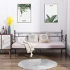 A daybed with pillows and a blanket is set up in a room with two nature-themed framed pictures on the wall. Voir les images du produit