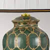 A close-up view of the top portion of a decorative table lamp. Podgląd zdjęcia produktu