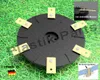 A trimmer head with multiple blades sits on a bed of grass, with inset diagrams showing blade attachment and German flag. Voir les images du produit