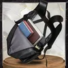 A black rucksack is shown open, with books and a small bottle inside. The background is a marble-like pattern with gold veins. Anteprima dell’immagine prodotto