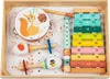 A wooden musical instrument set for children, including a xylophone, tambourine, maracas, and recorder, arranged in a wooden tray. Produktbild-Vorschau