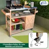A wooden serving trolley with a grill on top, set up outdoors on a patio with greenery in the background. Produktbild-Vorschau