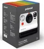 The image shows the packaging of a Polaroid Now Instant Camera, Generation 2. The box is dark gray with the Polaroid logo and a rainbow stripe at the top. The front of the box features an image of the white and black camera. Voir les images du produit