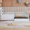 A white children's bed with a pull-out trundle bed, set against a padded headboard and a peach-colored wall. Decorative elephant and sheep figures are mounted on the wall. Produktbild-Vorschau
