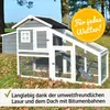 A wooden chicken coop with a run, set up outdoors on grass with fallen leaves. Produktbild-Vorschau