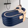 A woman is relaxing in an inflatable bathtub in a bathroom. Produktbild-Vorschau