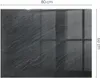 A dark gray, textured glass floor plate with reflective grid lines, likely for a fireplace, with dimensions indicated. Produktbild-Vorschau