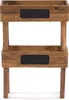 A two-tiered wooden planter box with black chalkboard labels on each tier, set against a white background. Produktbild-Vorschau