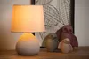A table lamp and decorative owl figurines are displayed on a wooden surface. Náhled obrázku produktu