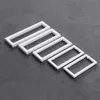 Five white rectangular frames are arranged diagonally on a gray surface. Produktbild-Vorschau