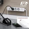 A power strip with multiple outlets and USB ports is shown plugged into a wall, with a soldering iron stand and a smartphone charging. Anteprima dell’immagine prodotto