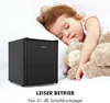 A sleeping child next to a mini-fridge. Produktbild-Vorschau