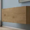 A close-up view of a wall-mounted wooden cabinet against a blue wall. Produktbild-Vorschau