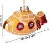 A yellow glass Christmas ornament shaped like a submarine, with red and blue accents, displayed against a white background with measurement indicators. Náhled obrázku produktu