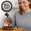 A woman is smiling while holding a digital thermometer that is inserted into a cooked steak. Anteprima dell’immagine prodotto