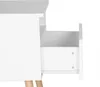 A close-up view of a white nightstand with an open drawer, showing its interior and drawer slides. The wooden legs are partially visible at the bottom. Náhľad obrázku produktu