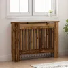 A wooden radiator cover is placed in front of a window. Podgląd zdjęcia produktu