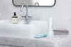 A bathroom sink with a faucet, soap dispenser, and a water flosser. Podgląd zdjęcia produktu