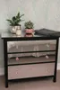 A mirrored dresser with decorative items on top. Náhľad obrázku produktu