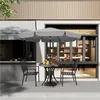 An outdoor seating area with a table and chairs under an umbrella. Produktbild-Vorschau