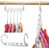 Multiple white plastic garment organizers with clothes hanging on them, displayed on a wooden rod. Podgląd zdjęcia produktu