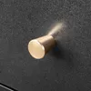 A close-up of a gold drawer knob on a textured black surface. Náhľad obrázku produktu