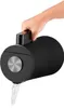 A hand is holding a black electric kettle and pouring water from it. Podgląd zdjęcia produktu
