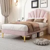 A pink upholstered bed with a shell-shaped headboard is set up in a bedroom with curtains and wall decor. Produktbild-Vorschau