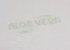 A close-up of a white textured surface with the words "ALOE VERA" printed in green. Produktbild-Vorschau