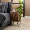 A bedroom scene with a nightstand next to a bed, featuring a plant and a glass of water. Produktbild-Vorschau