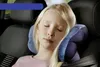 A young girl sleeping in a car seat with a travel pillow. Podgląd zdjęcia produktu