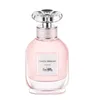 A bottle of Coach Dreams Eau de Parfum for women. Voir les images du produit