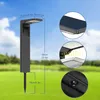 A solar-powered garden light is shown in a grassy outdoor setting with a blue sky and clouds. Multiple close-up views highlight its features. Náhľad obrázku produktu