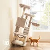A cat tree is placed next to a wall with a window in the background. A cat is standing on the floor in front of the cat tree. Anteprima dell’immagine prodotto