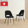 Two black chairs are shown in a room with a light-colored wall and wooden floor. Náhled obrázku produktu