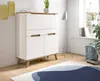 A modern white and wood secretary desk in a bright room with a window and a floor lamp. Produktbild-Vorschau