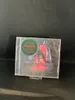 A CD case is displayed on a black surface. Produktbild-Vorschau