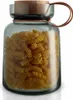 A glass storage jar filled with fusilli pasta, with a wooden lid and leather handle. Voir les images du produit