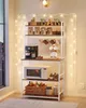 A kitchen baker's rack with coffee maker, microwave, mugs, and various bottles and jars. Náhled obrázku produktu