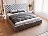 A bedroom scene with a tufted upholstered bed as the main focus. Produktbild-Vorschau