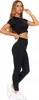 A woman wearing black leggings and a black crop top, posing against a white background. Produktbild-Vorschau