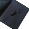 A close-up of a black waterproof cover with water droplets on it. Náhľad obrázku produktu