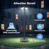 A solar-powered garden lamp is shown in a nighttime outdoor setting with rain falling, highlighting its weather resistance. Náhled obrázku produktu