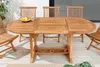 An oval wooden garden table with chairs on a wooden deck. Produktbild-Vorschau
