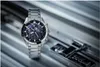 A silver Casio Edifice watch is placed on a metallic surface, with part of a combination lock visible in the background. Voir les images du produit